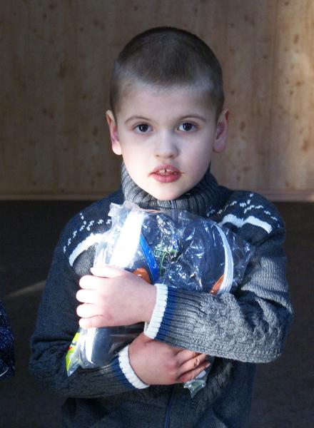 Die neue Winterkleidung fest in den Händen. Kind hält die neue Winterkleidung in Händen.