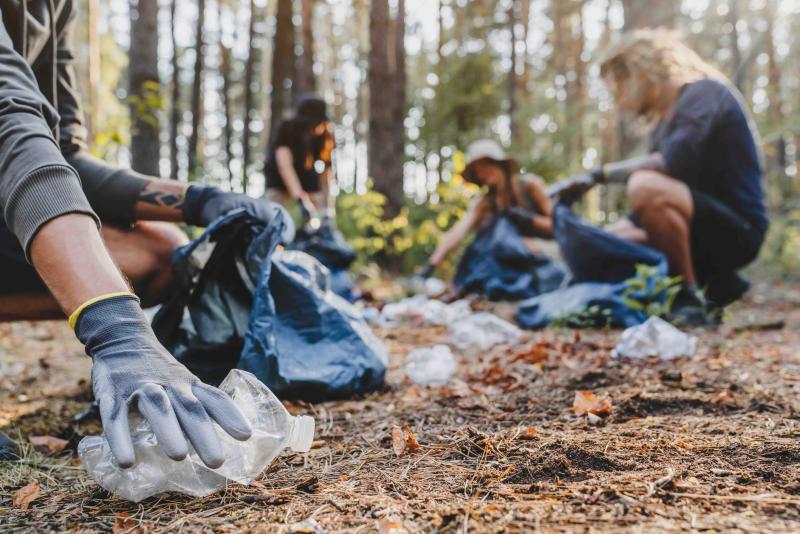 Menschen beim Müllsammeln in der Natur