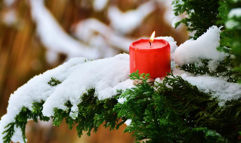 Kerze brennt auch Tanne mit Schnee