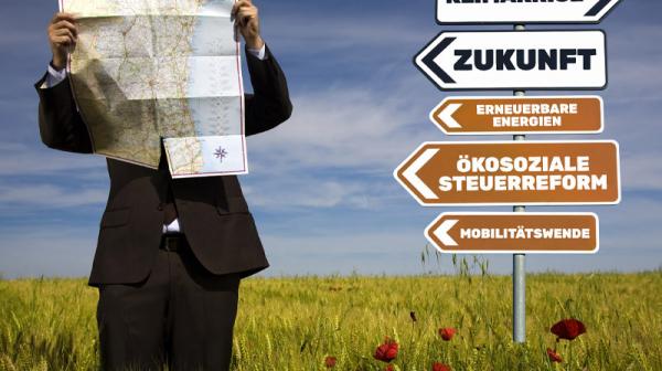 Bild zu Vienna Forum on Climate Action - Mann mit einer Landkarte, der in einem Feld neben einem Wegweiser steht, auf dem Klimakrise, Zukunft, Ökosoziale Steuerreform, Mobilitätswende und erneuerbare Energien steht